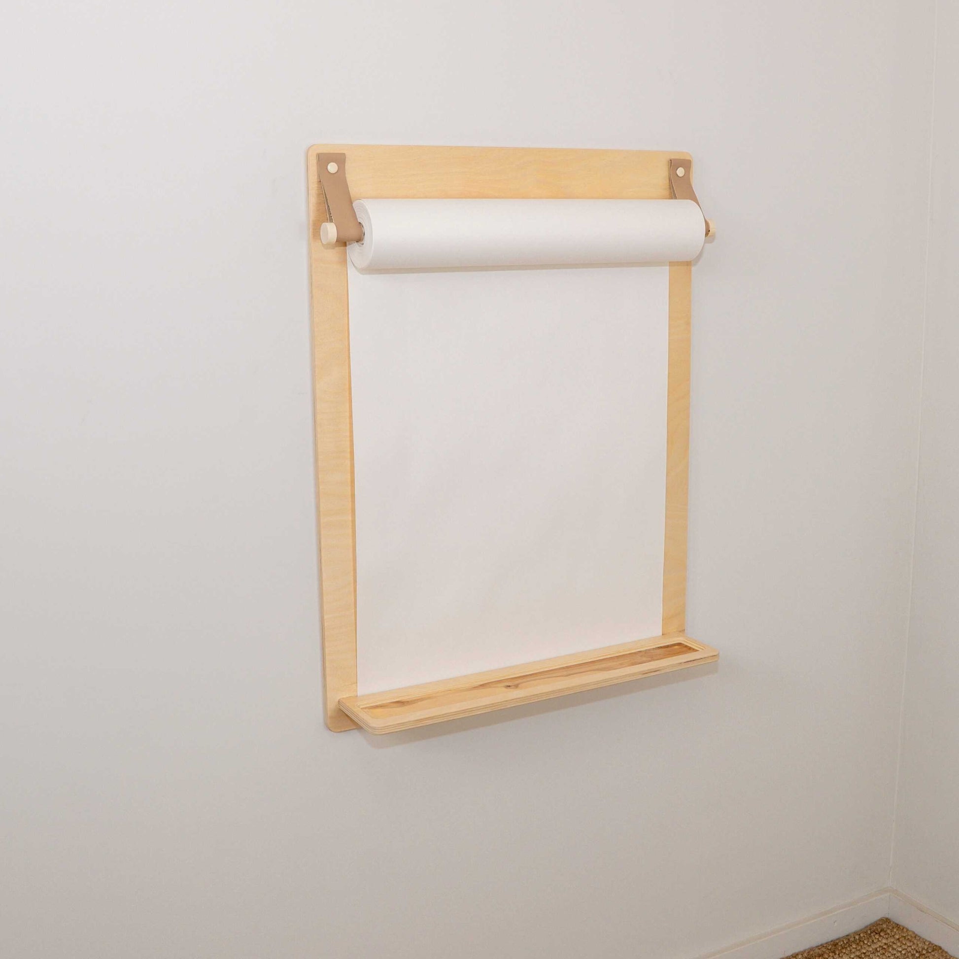 Wooden wall-mounted drawing board with built-in paper roll holder, front view