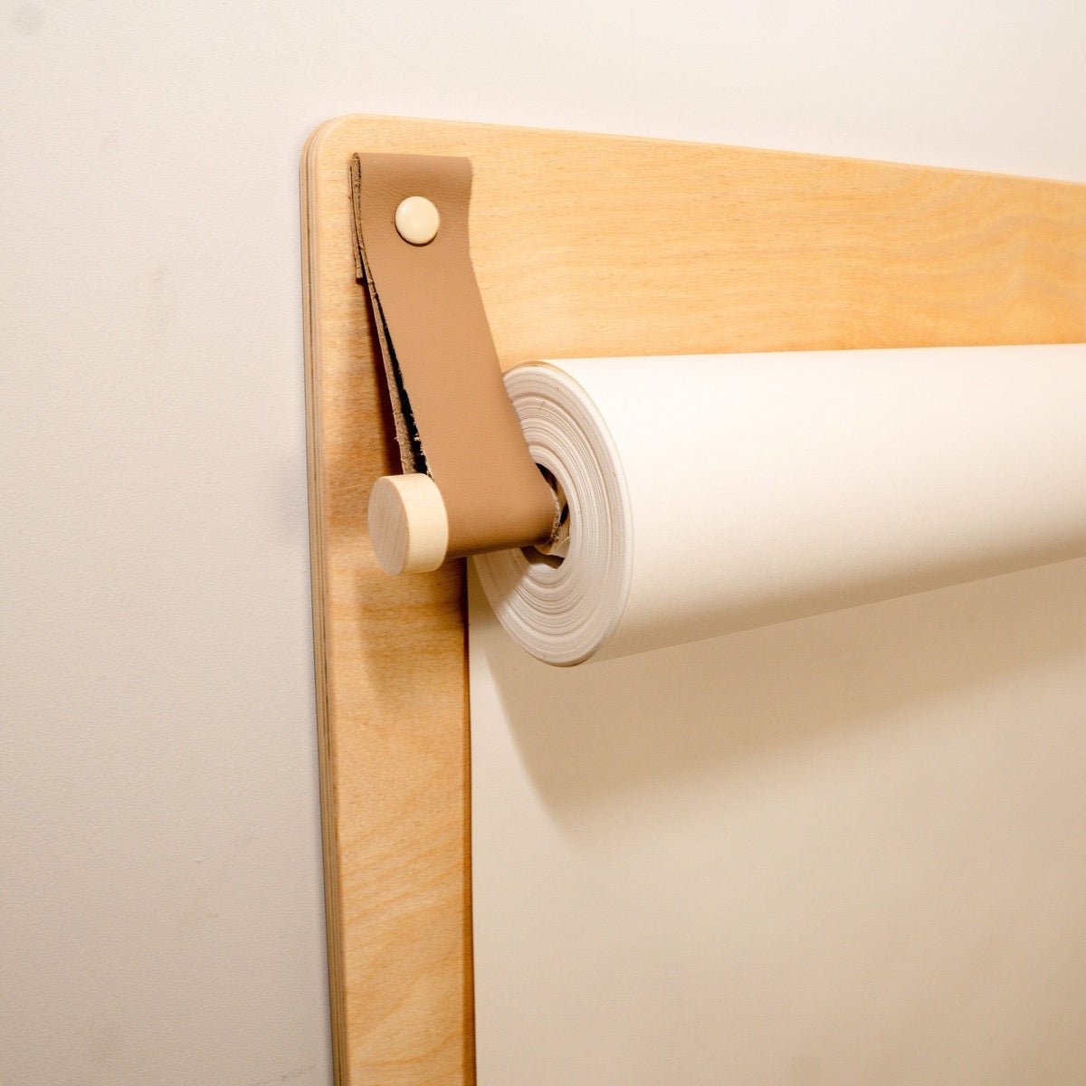 Detail of paper roll holder mechanism with leather strap on drawing board