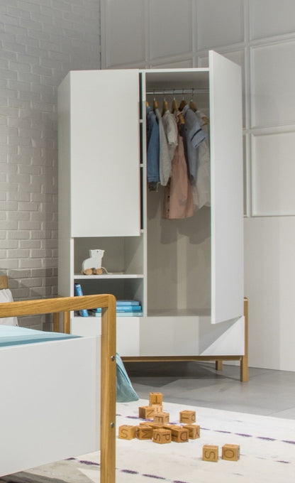 Victor wardrobe with open doors showing hanging clothes, drawers, and open shelving in a Scandinavian children's room