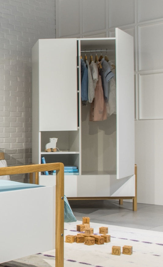 Victor wardrobe with open doors showing hanging clothes, drawers, and open shelving in a Scandinavian children's room