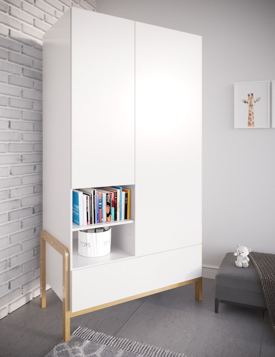 White Victor wardrobe with books and storage in open cubby, closed doors, and oak legs against white brick wall