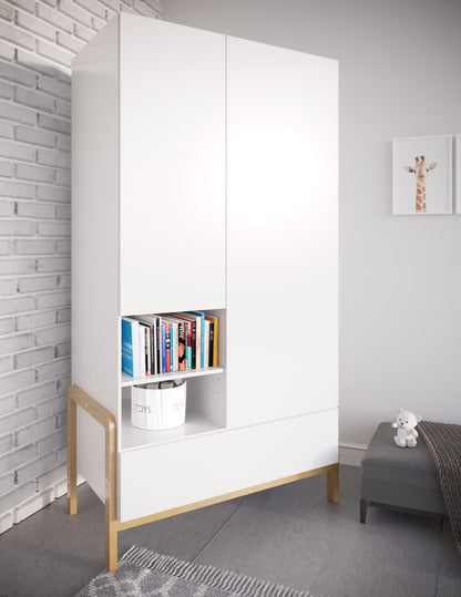 White Victor wardrobe with books and storage in open cubby, closed doors, and oak legs against white brick wall