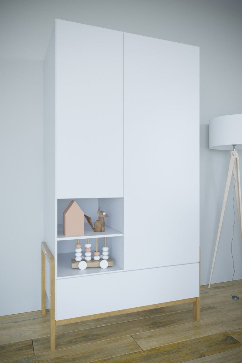 Victor wardrobe front view with closed doors, open gray shelving displaying toys, and solid oak legs on wood floor