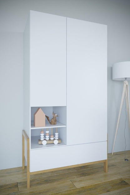 Victor wardrobe front view with closed doors, open gray shelving displaying toys, and solid oak legs on wood floor