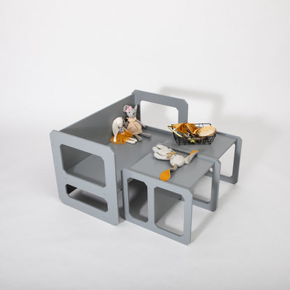 Gray Montessori weaning table set with chair and storage compartments containing toy food items