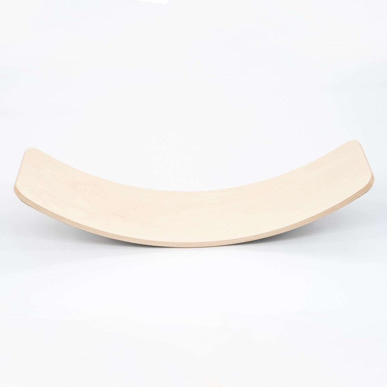 Natural wooden balance board with curved surface, side view on white background