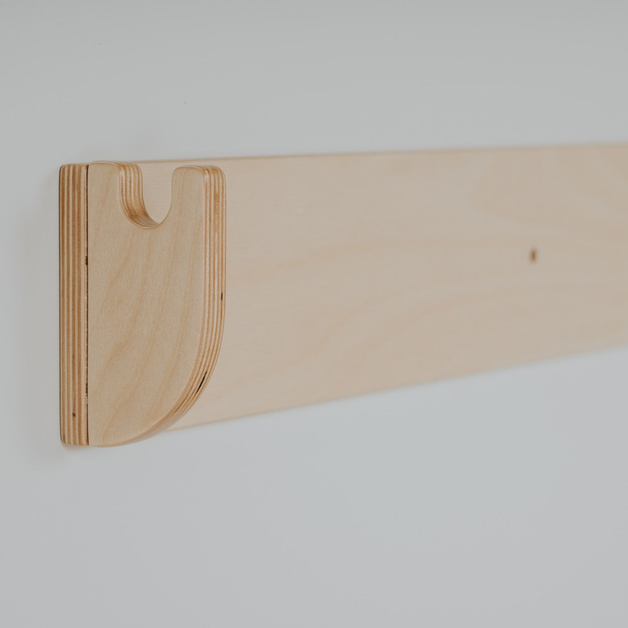 Close-up of curved wooden hand hold on Swedish wall climber