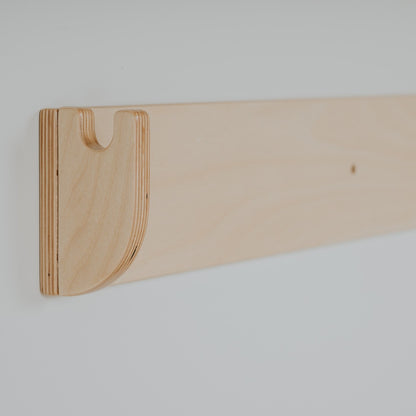 Close-up of curved wooden hand hold on Swedish wall climber