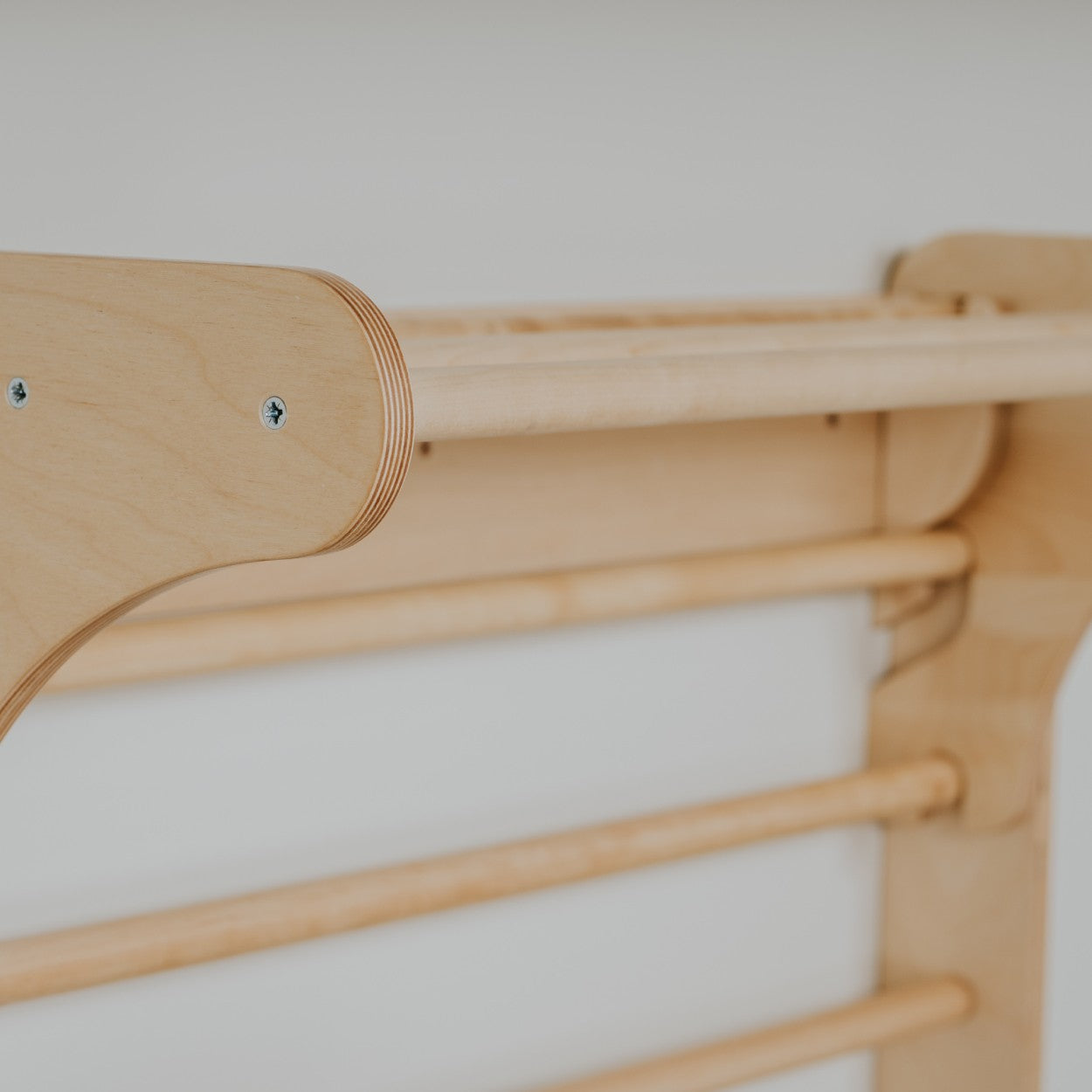 Detail of wooden peg attachment points on Pikler triangle leg
