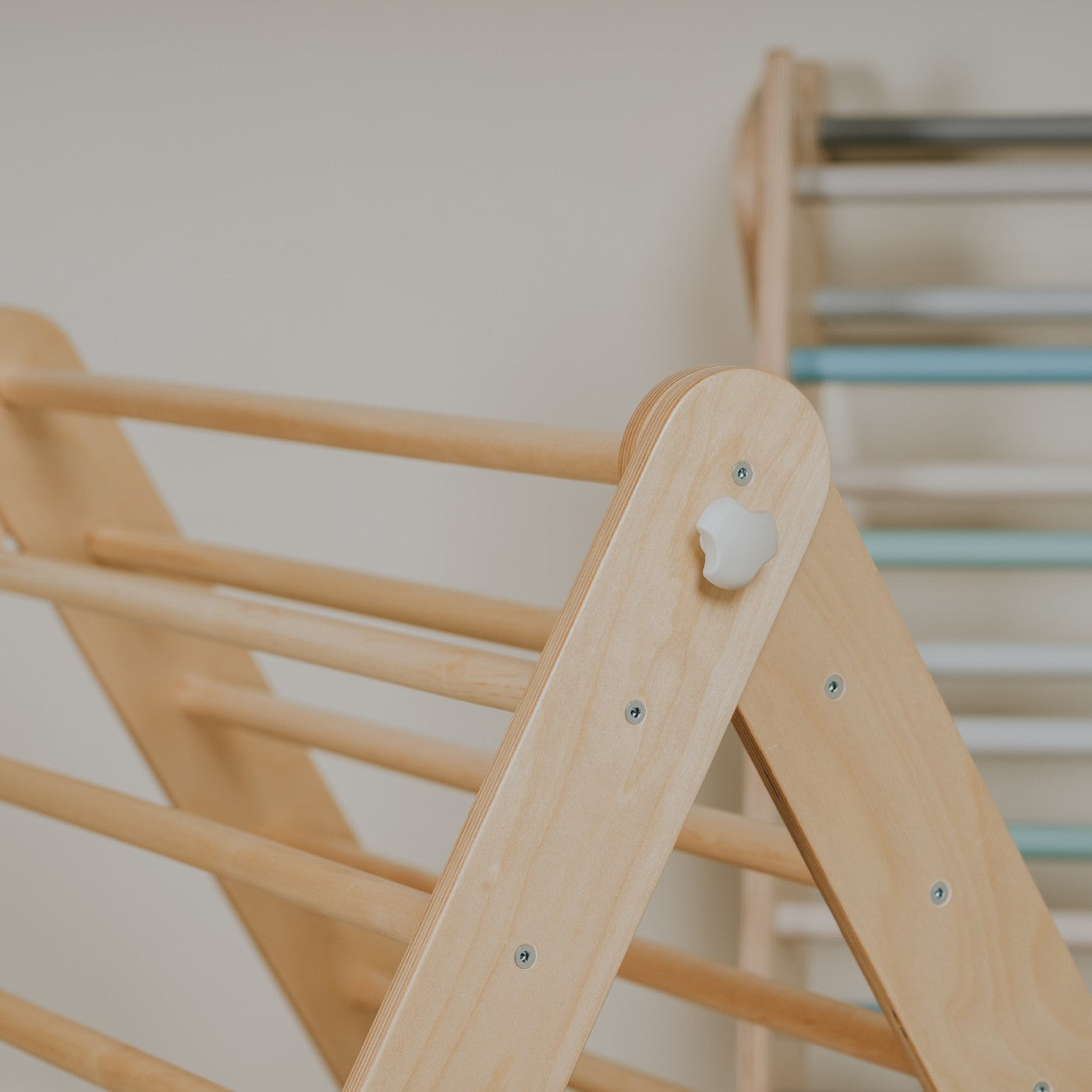 Wooden rungs and peg detail on natural birch Pikler climber