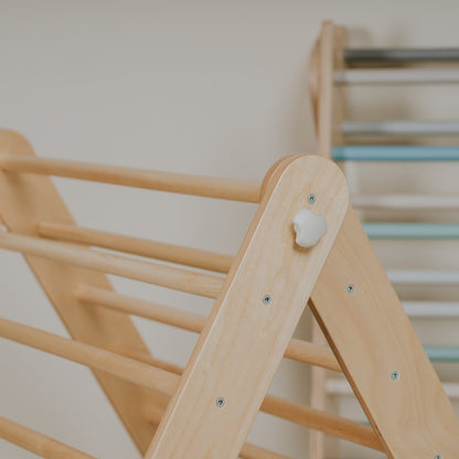 Wooden rungs and peg detail on natural birch Pikler climber
