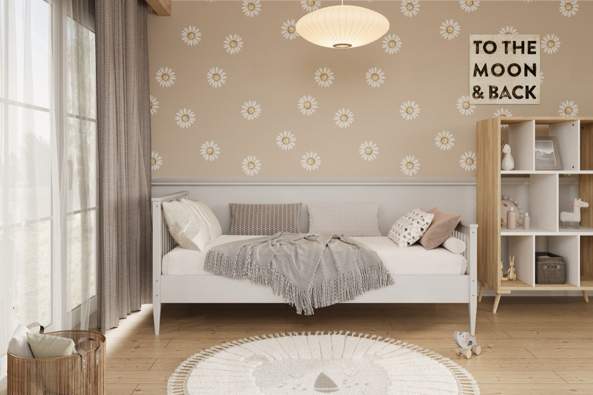 White Emilia pine bed in nursery interior scene with textured bedding and accessories