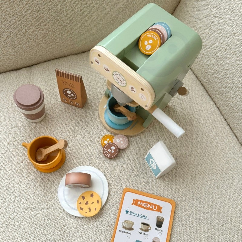 Overhead view of wooden coffee maker with pastry cookies and milk carton on beige carpet during play