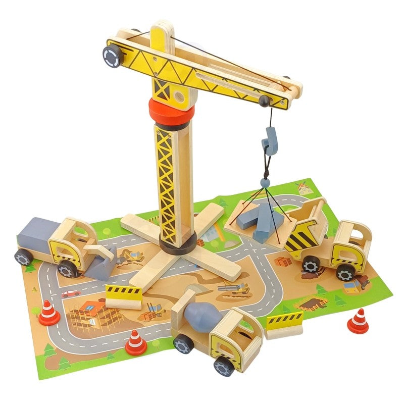 Wooden construction crane on green play mat with multiple vehicles and traffic cone accessories