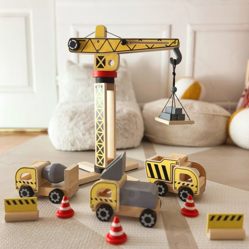 Wooden construction site crane set with rotating arm, vehicles and traffic cones in nursery