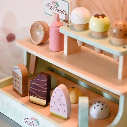 Close-up of ice cream shop shelves displaying magnetic scoops in various colors and popsicles with different patterns