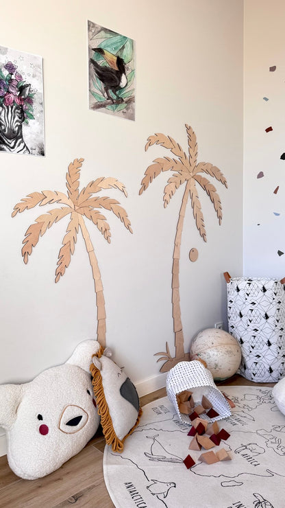 Pair of wooden palm tree wall decor mounted on beige wall above playroom accessories