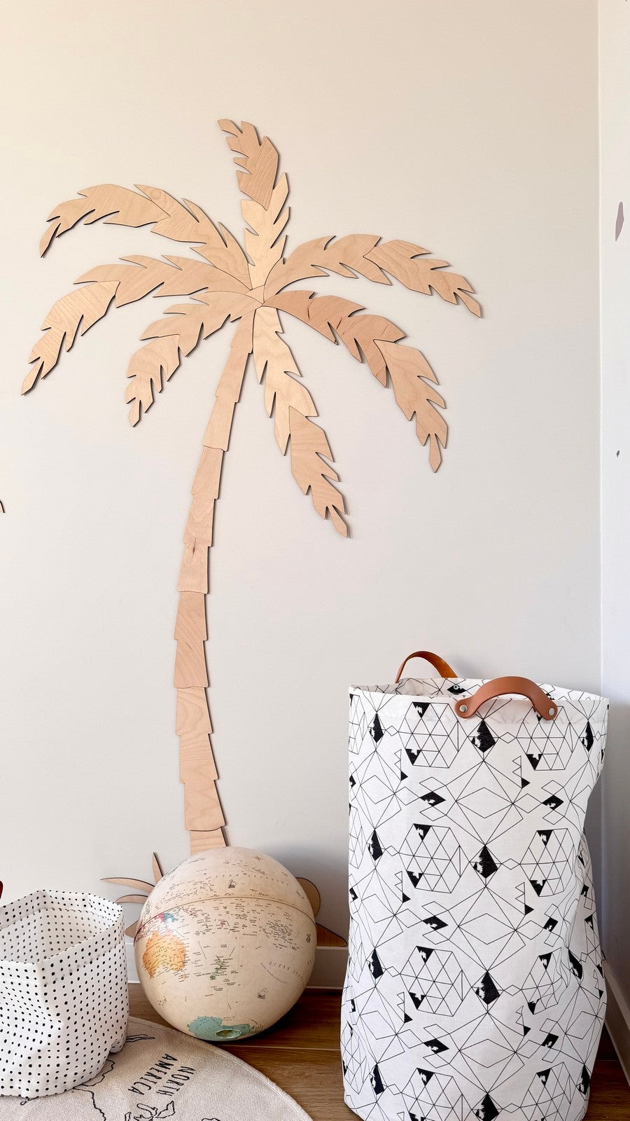 Single tall wooden palm tree wall decor with natural plywood finish in child's room