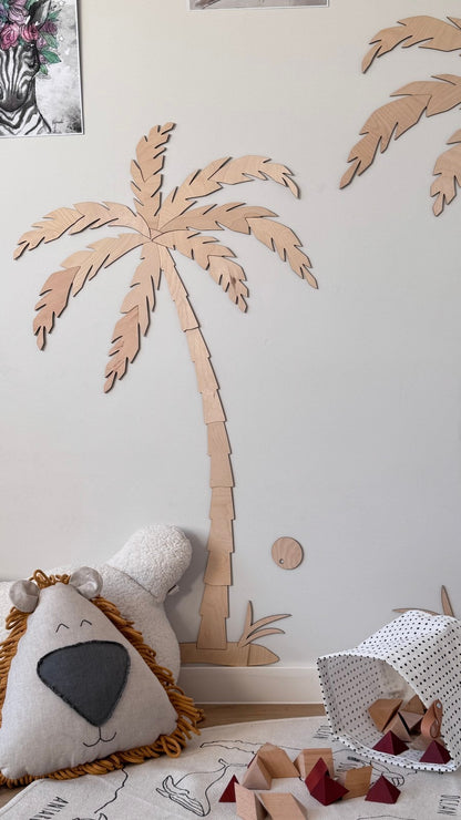 Close-up of hand-cut wooden palm tree showing detailed leaf texture and natural finish