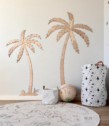 Two wooden palm trees of different sizes displayed as tropical wall decor set
