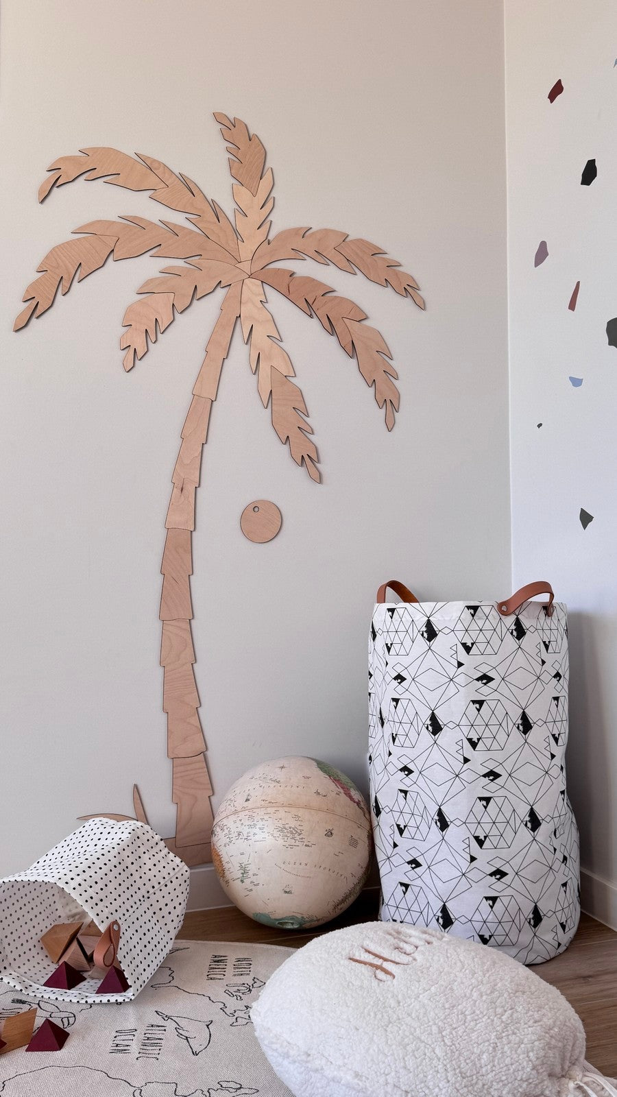 Large wooden palm tree wall decor with natural plywood grain visible in playroom