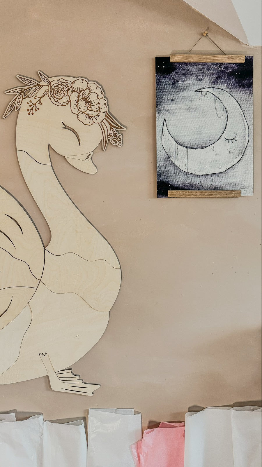 Close-up of assembled swan wooden decoration head with detailed floral crown detail on plywood