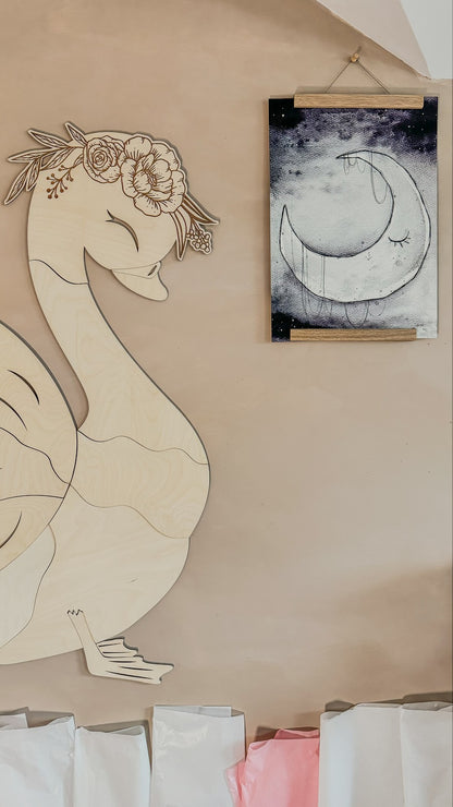 Close-up of assembled swan wooden decoration head with detailed floral crown detail on plywood