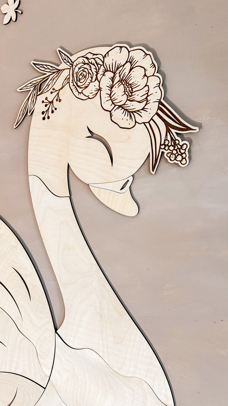 Swan wooden wall art close-up showing head profile with intricate flower crown and feather details
